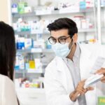 Millions Skipped the Doctor. Now It’s Expanding Pharmacist wearing mask explains medication to customer