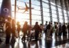 Court Storms Plane Over Unpaid Millions Passengers queue inside an airport terminal at sunset