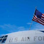 The Airman America Refused To Leave Behind American flag on U.S. Air Force aircraft against blue sky