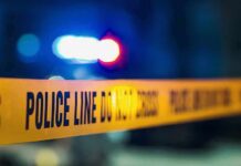 ‘Antichrist’ Claim Precedes Basement Horror Police tape with blurred flashing lights in background
