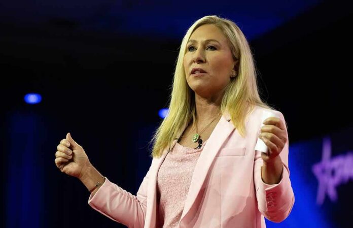 shutterstock_2270821387 Woman in pink blazer speaking on stage