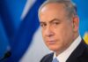 Empty Seats Humiliate Israel Defense man in suit at podium