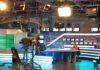 News studio with anchor at desk and cameras
