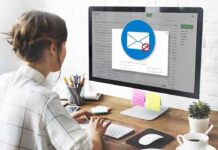 Woman using desktop computer with email warning popup
