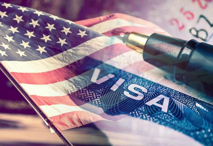 shutterstock_624512744 American flag overlaid on a U.S. visa and a pen