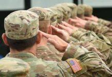 America Just Closed a 23-Year Chapter Soldiers in camouflage uniforms saluting in formation