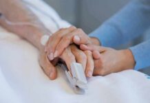 A Final Decision Leaves a Family Demanding Answers Hands holding in a hospital bed