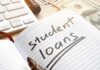 Shock Move: Paychecks Hit Without Court Notebook with student loans written, marker, cash, and keyboard