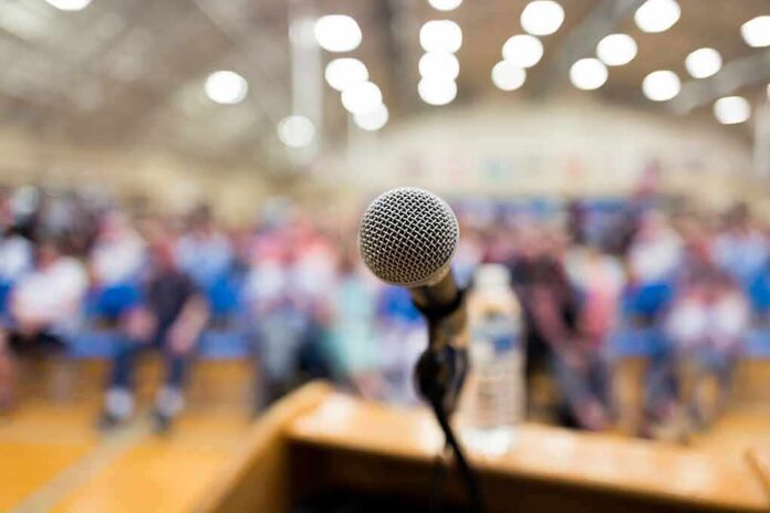microphone on a podium facing a blurred audience