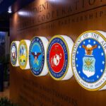 Military department seals displayed on a wall