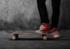 California Heist Gone Hilariously Wrong Person standing on a skateboard wearing red sneakers