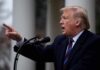 Donald Trump speaking at a podium and pointing
