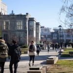students walking on a university campus pathway