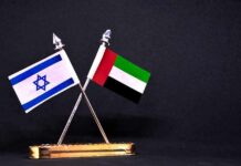 Israeli and UAE flags on crossed desk stand