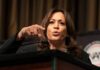 Woman speaking at a podium and gesturing with her hand