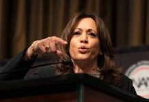 Woman speaking at a podium and gesturing with her hand
