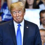 Rally Chaos Erupts – Trump Applauds The Punch Donald Trump with eyes closed and pursed lips at an event