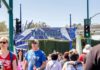 Disneyland Sidewalk Sealed After Body Crowd walking past a Disneyland Resort entrance sign