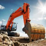 orange excavator digging at a construction site