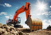 orange excavator digging at a construction site