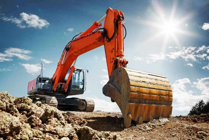 orange excavator digging at a construction site