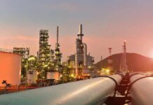 The Hidden Financial Cost of a Blocked Waterway Oil refinery with pipelines at sunset