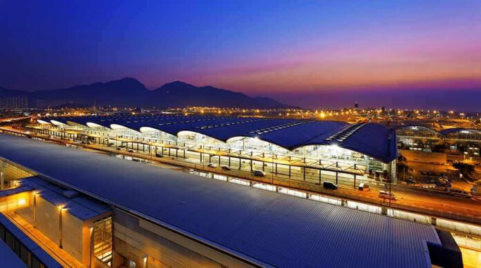 shutterstock_174669458 Airport terminal at dusk with illuminated wave-like roof
