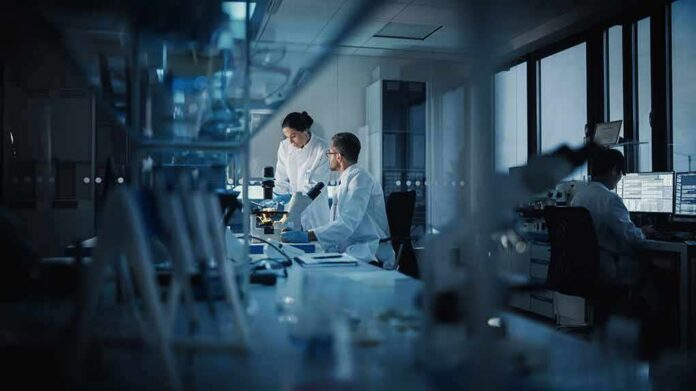 Scientists working in a dim laboratory