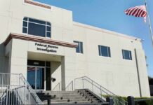 A $1 Million Manhunt Just Went Global FBI office building with entrance steps and American flag