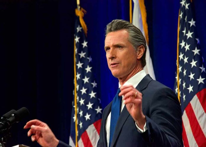 Gavin Newsom speaking at a podium with American flags in the background