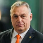 Orbán Allies Cornered – Files, Raids, Fallout Viktor Orbán in a dark suit with an orange tie at an event