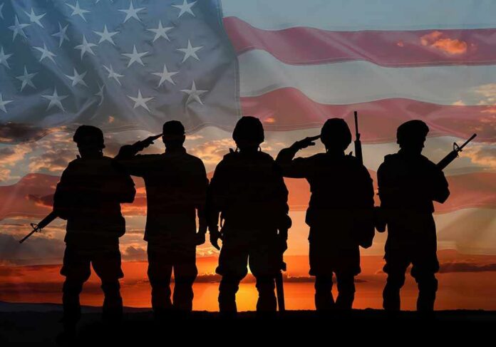 Veterans,Day.,Silhouettes,Of,Military,Men,On,Sunset,Outdoors,And Soldiers saluting at sunset with American flag overlay