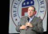 Mike Huckabee speaking on stage with a microphone