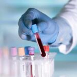 T-Checks Crackdown Hits Troops 30+ Gloved hand holding a blood sample tube