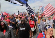 Dennis Erickson, Carlos Hyde, and Danny Hope among a crowd at a patriotic rally