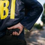 FBI Nabs Teen Before Alleged Hit FBI agent in jacket drawing a handgun