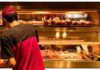 Worker stocking fried food display case