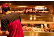 Worker stocking fried food display case